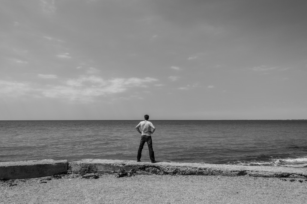 A man looks out at sea near the beach in Calamita Bay (35 km North of Sevastopol) where the French troops landed in September 1854, during the Crimean War. Crimea, 24 June 2014.