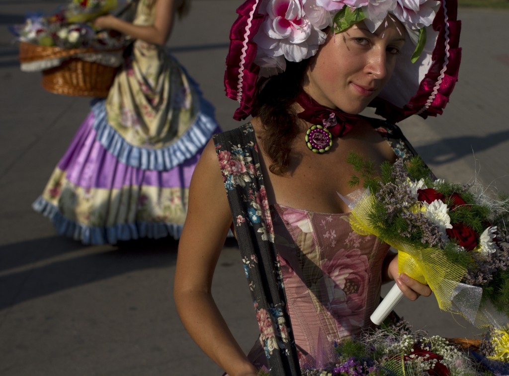 Girls wearing old time dresses are selling flowers on the Kornilova Embarkment in Sevastopol. Crimea 01.08.2014