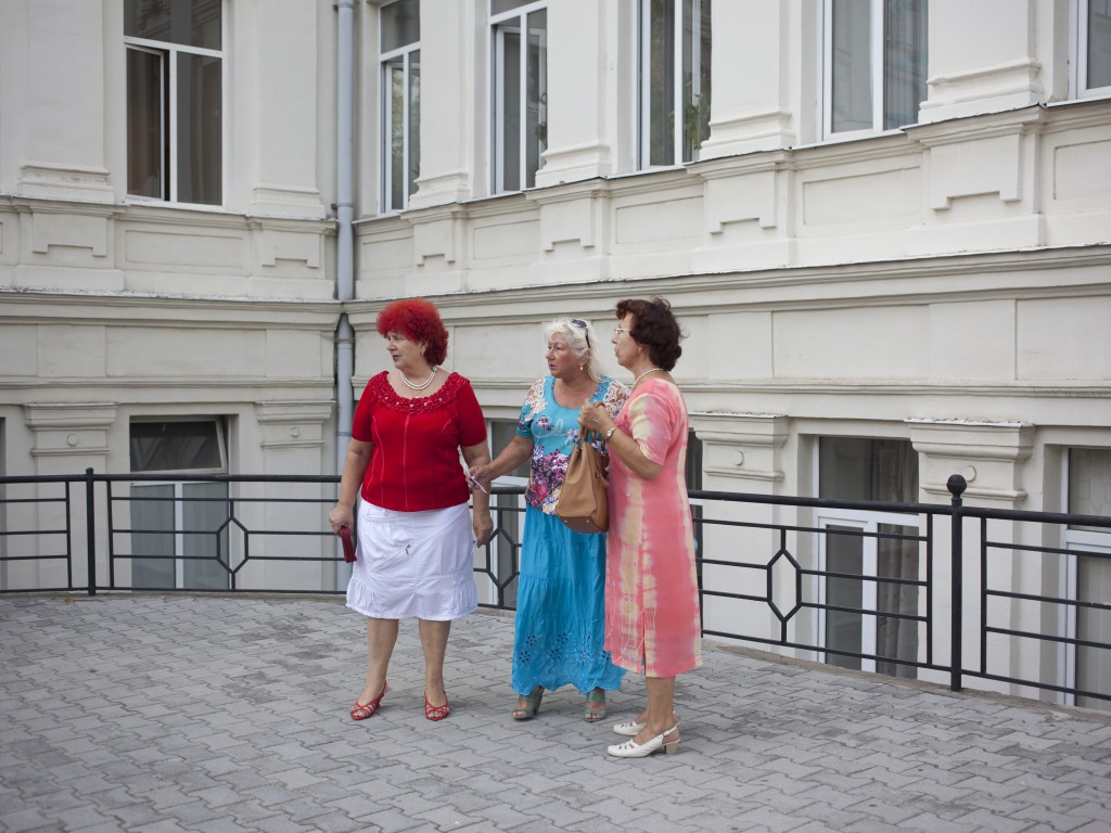 Women attending a performance called Izbrannoe in Vadim Elizarov Academic Dance Theatre in Sevastopol are photographed by the entrance to the theatre. Crimea. 03.08.14